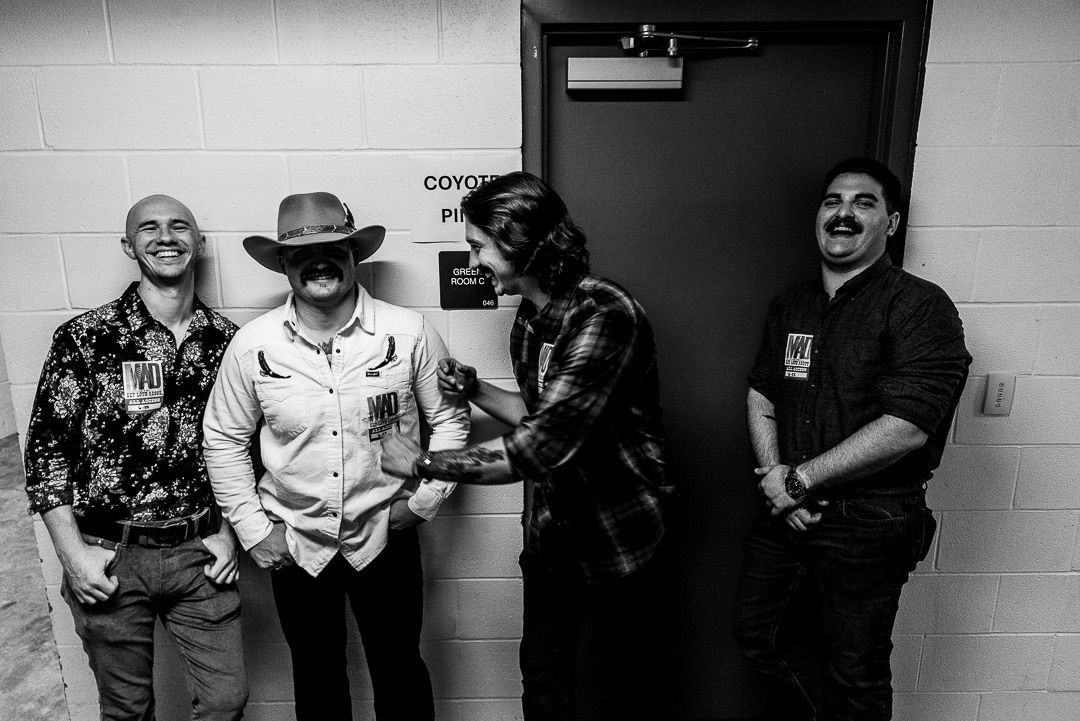 The band laughing backstage