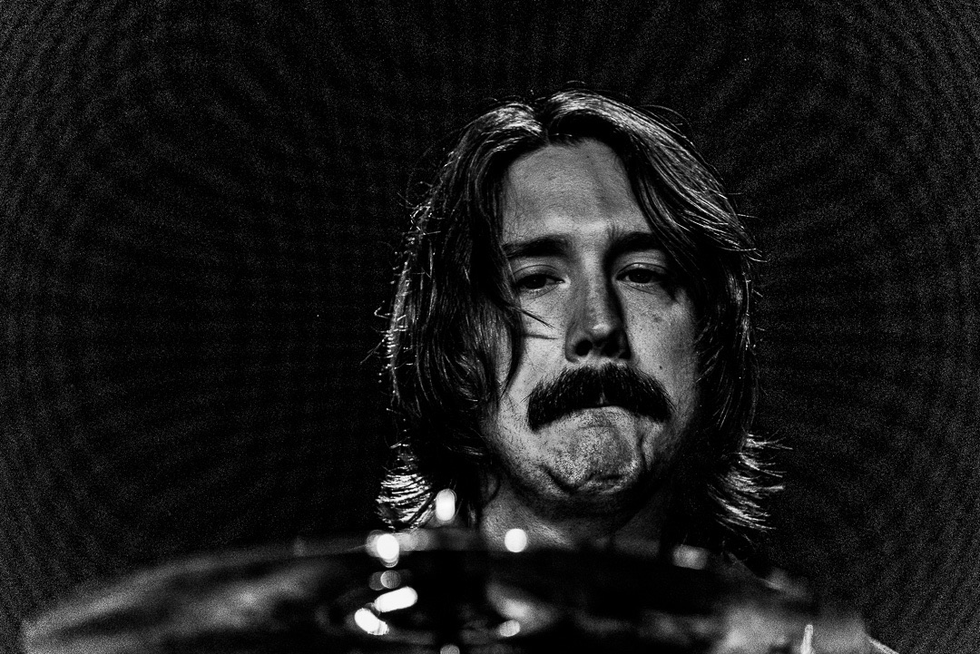 Jon mid-song behind the cymbals