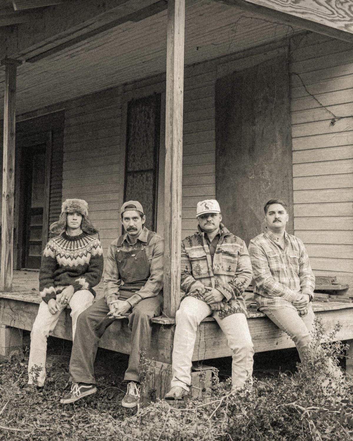 Official Coyote Pine artist photo: the band on a farmhouse porch. Left to right: Matt Peace, Jonathan Chambers, Micah Hughes, Tanner “Rooster” Barnett